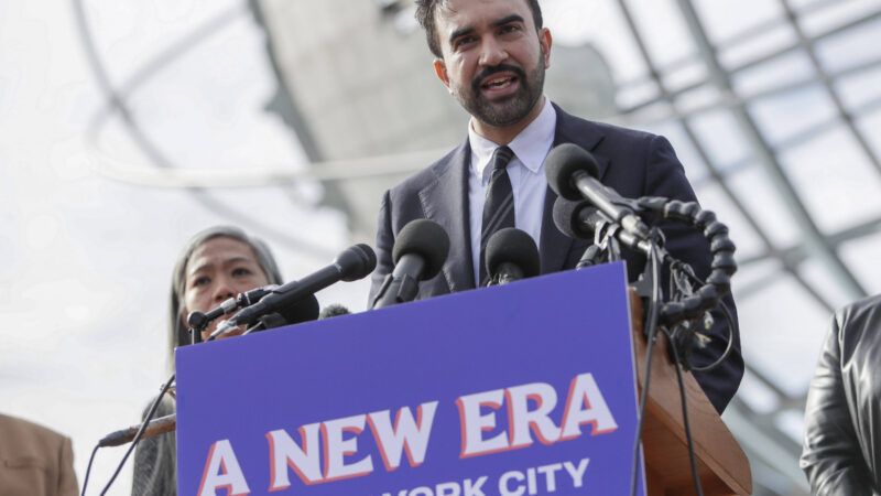 New York City Mayor-elect Zohran Mamdani addresses a crowd, behind a campaign sign that says "A New Era for New York City." | Andrew Schwartz/SIPA/Newscom