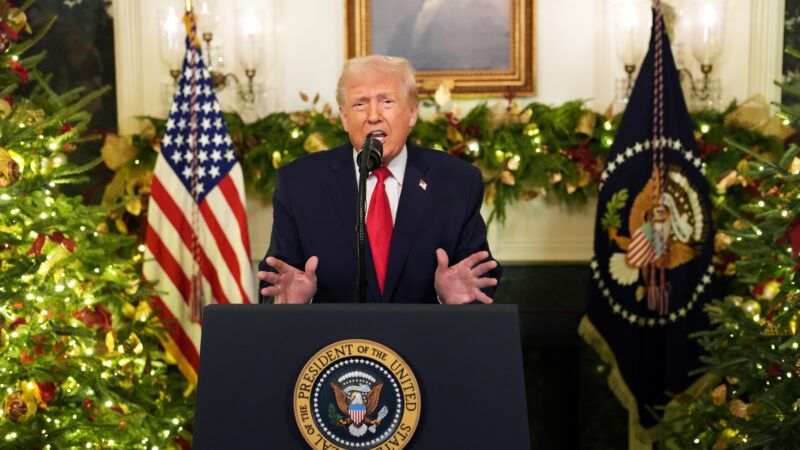 Donald Trump standing in front of a lectern with Christmas decorations behind him | Doug Mills/The New York Times/UPI/Newscom