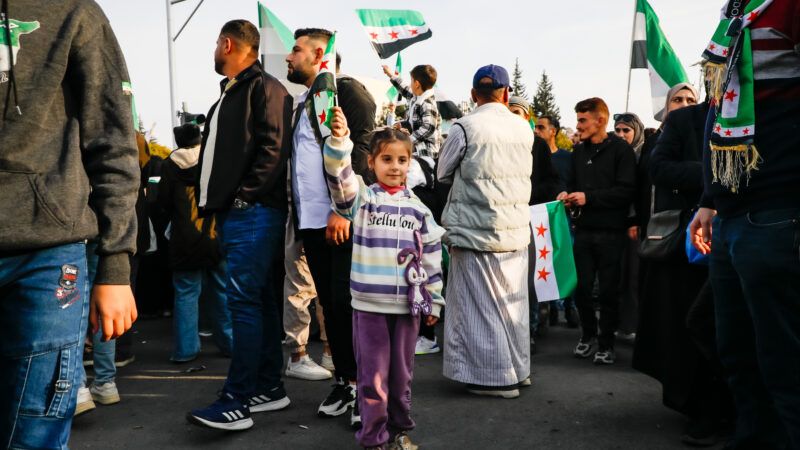 Thousands of Syrians gather in Umayyad Square in central Damascus to celebrate the anniversary of the military operation that led to the fall of Bashar al-Assad's regime. | Mohammad Bashir Aldaher/ZUMAPRESS/Newscom