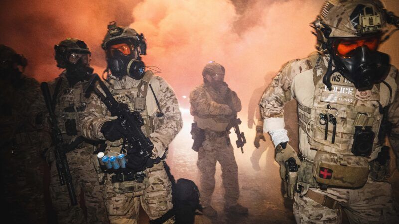 Police in gear while deploying tear gas | Dave Decker/ZUMAPRESS/Newscom