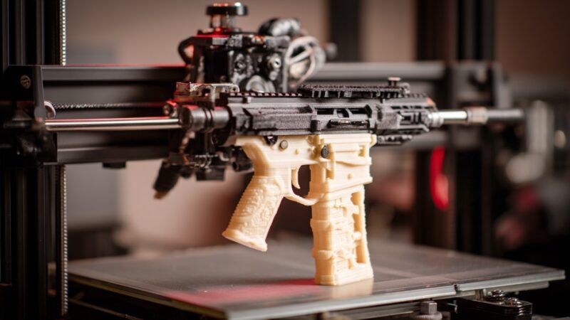A semiautomatic rifle akin to the AR-15 being printed by a 3D printer. | Midjourney