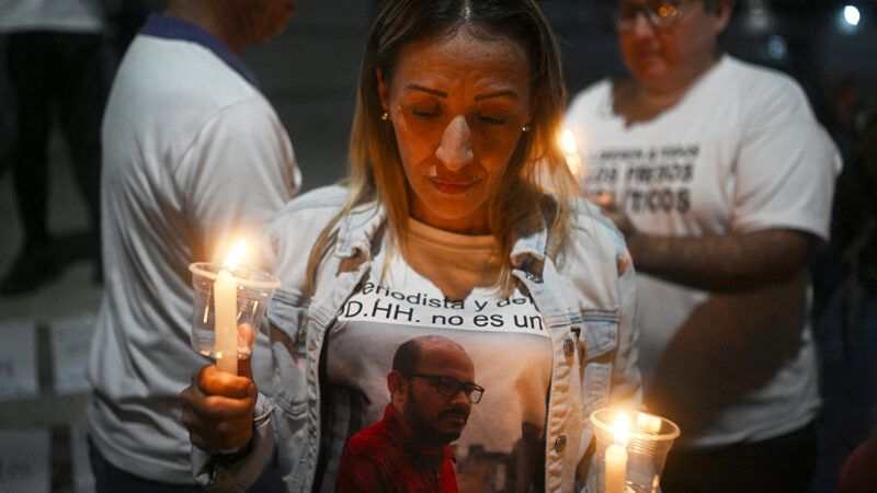 People holding candles at a vigil | Photo: Federico Parra/AFP/Getty