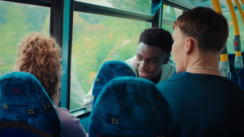 Students talk on a school bus, in an image from an ad. | Transport for London/Youtube