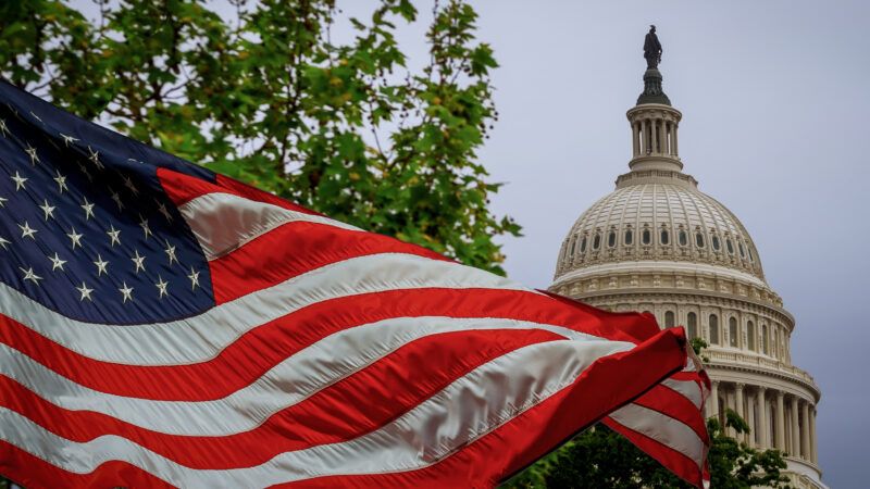 An American flag flaps, with the U.S. Capitol in the background. | Photovs/Dreamstime