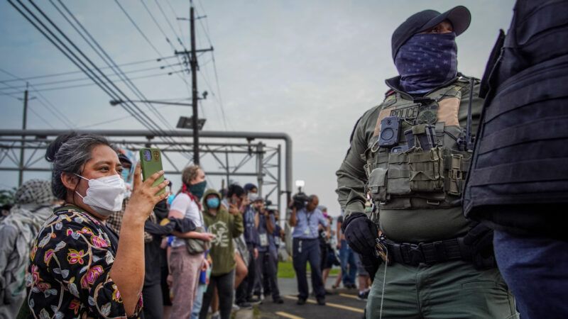A protester records immigration agents | Derek French/SOPA Images/Sipa USA/Newscom