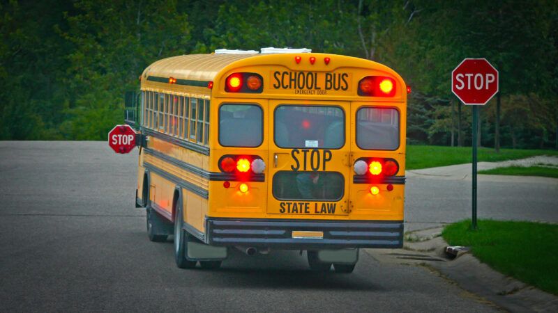 A yellow school bus at a stop sign | Sonya Etchison/Dreamstime