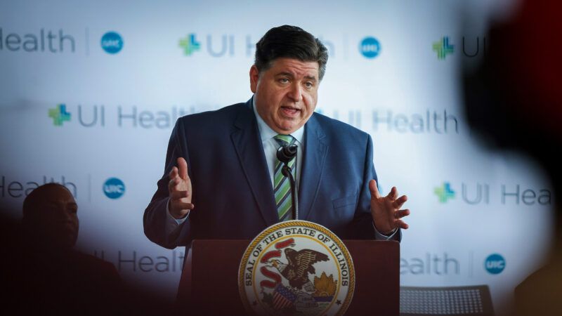 Illinois Gov. J.B. Pritzker speaks at a lectern with the Illinois seal on it, in front of a background that has the UI Health logo multiple times. | Photo: Eileen T. Meslar/TNS/Newscom