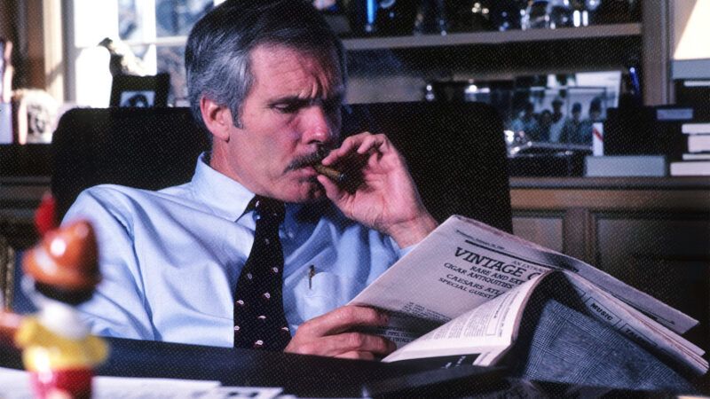Ted Turner smoking a cigar and reading a newspaper | Robin Rayne/ZUMAPRESS/Newscom