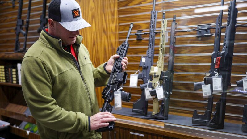 Man holding a firearm in a store | Photo: John J. Kim/TNS/Newscom