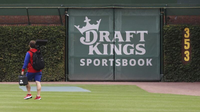 A logo for "DraftKings Sportsbook" is pictured on the outfield wall of Wrigley Field, surrounded by ivy. | John J. Kim/TNS/Newscom