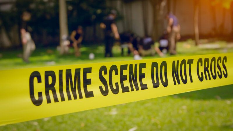 a crime scene behind yellow police tape | Prathan Keawkhum/Dreamstime