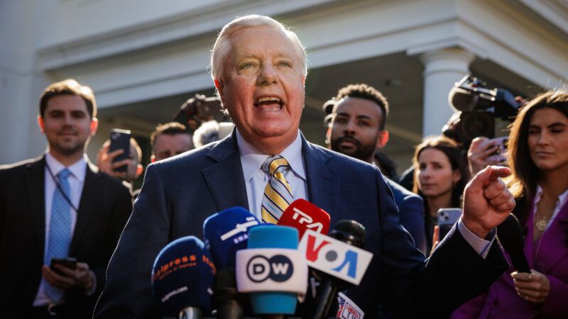 Sen. Lindsey Graham speaks into microphones surrounded by supporters | Samuel Corum/Sipa USA/Newscom