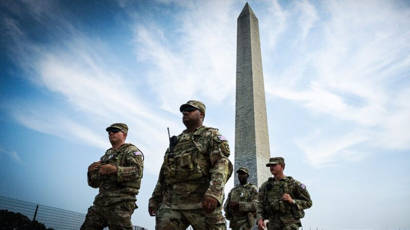 National Guard members in front of the Washington Monument | Photo: Graeme Sloan/Sipa USA/Newscom