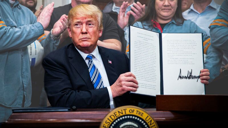 President Donald Trump holding up his aluminum tariff order | Michael Reynolds/dpa/picture-alliance/Newscom