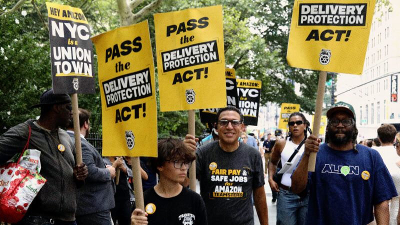 People hold signs in favor of New York City's Delivery Protection Act | IMAGO/ZUMA Press/Newscom