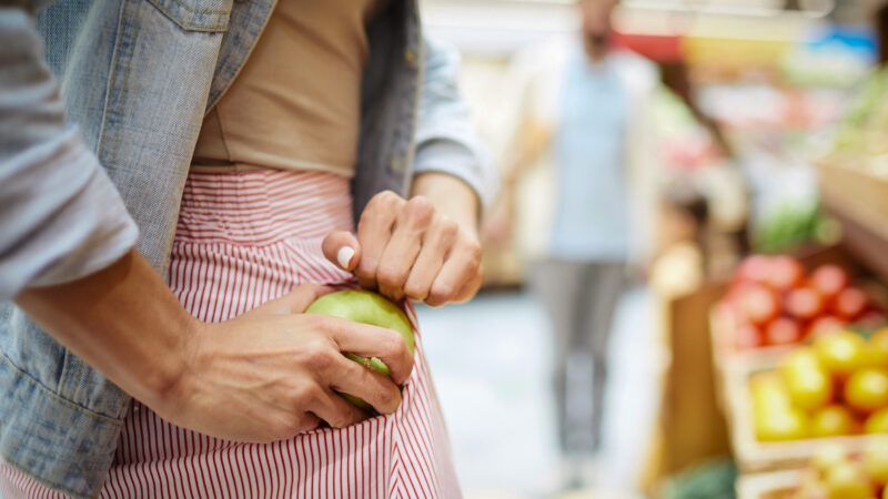 Someone shoplifting an apple | DPST/Newscom