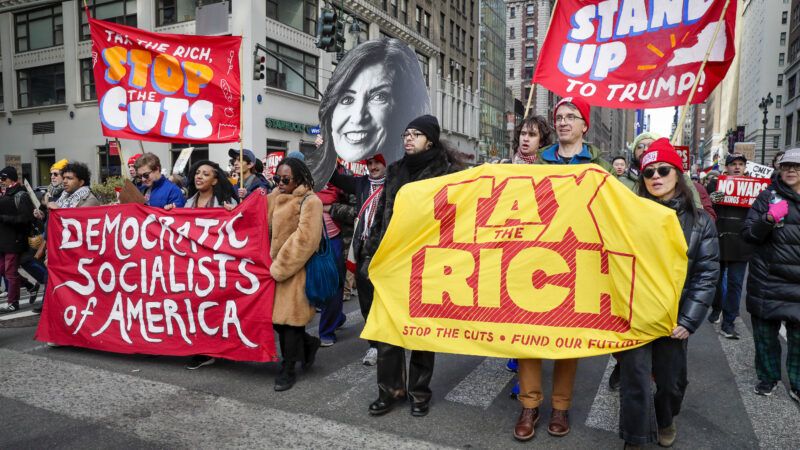 Members of Democratic Socialists of America (DSA) march with protest signs that say "Tax the Rich" and "Stop the Cuts." | Andrew Schwartz/SIPA/Newscom