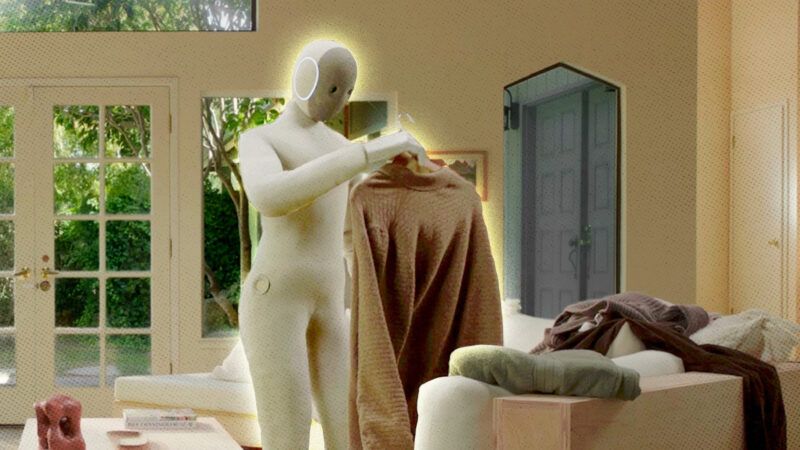 A photo of a humanoid robot handling clothes in a living room | X1