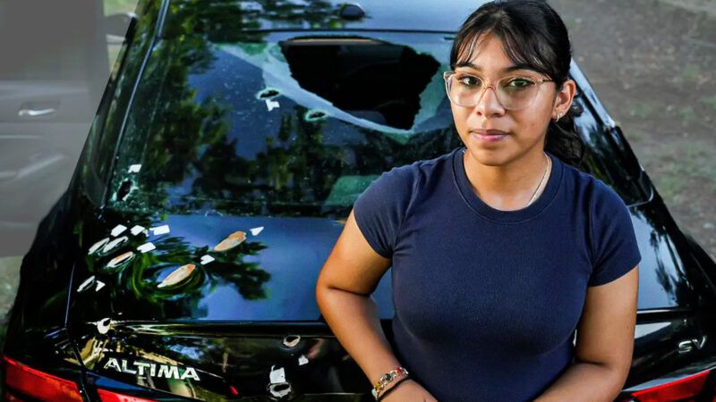 Abigail Trujillo in front of her totaled vehicle | Brett Coomer/Houston Chronicle