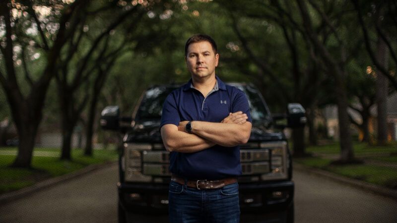 Alek Schott stands on a street in front of a vehicle | Institute for Justice