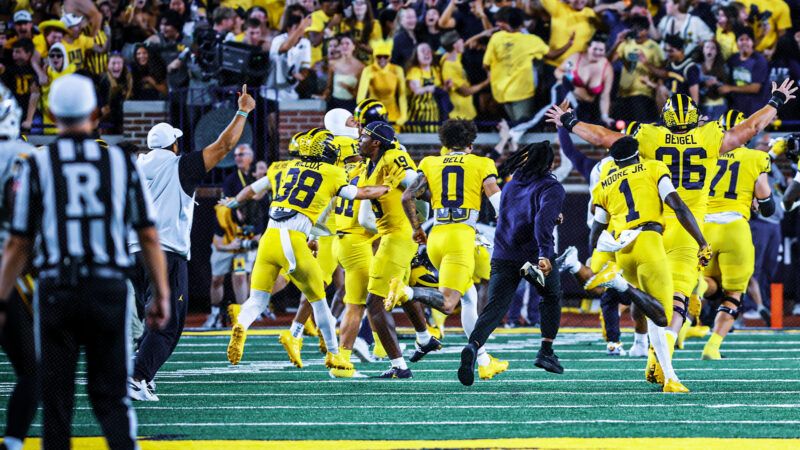 Michigan players in all-maize jerseys storm the field after a winning Hail Mary. | Scott W. Grau/Icon Sportswire CBW/Scott W. Grau/Icon Sportswire/Newscom