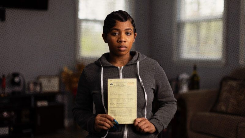 Brittany Coleman holds the towing bill she received after a bogus traffic stop in Brookside, Alabama | Institute for Justice