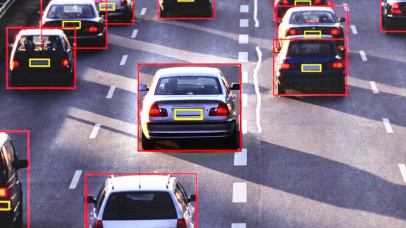 An image of cars driving down a highway, four lanes wide, with red boxes around the cars and yellow boxes around their license plates. | Adani Samat/AltrendoImages/Envato/ChatGPT
