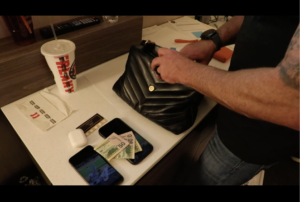 FBI agent rifling through a woman's purse