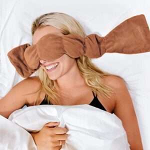 Woman sleeps with Nodpod sleep mask