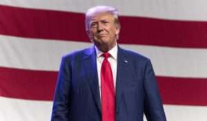 Donald Trump in front of a large American flag