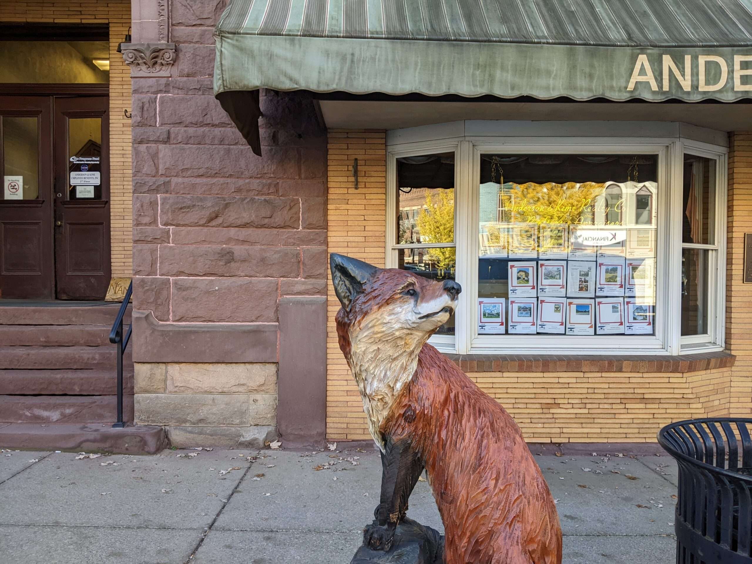 Carving of a fox in front of a storefront in Appalachia