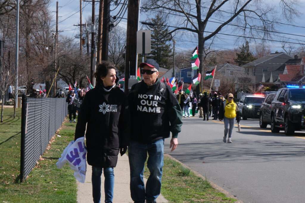 Two members of Jewish Voice for Peace walk ahead of a protest in Teaneck, New Jersey, on March 10, 2024.