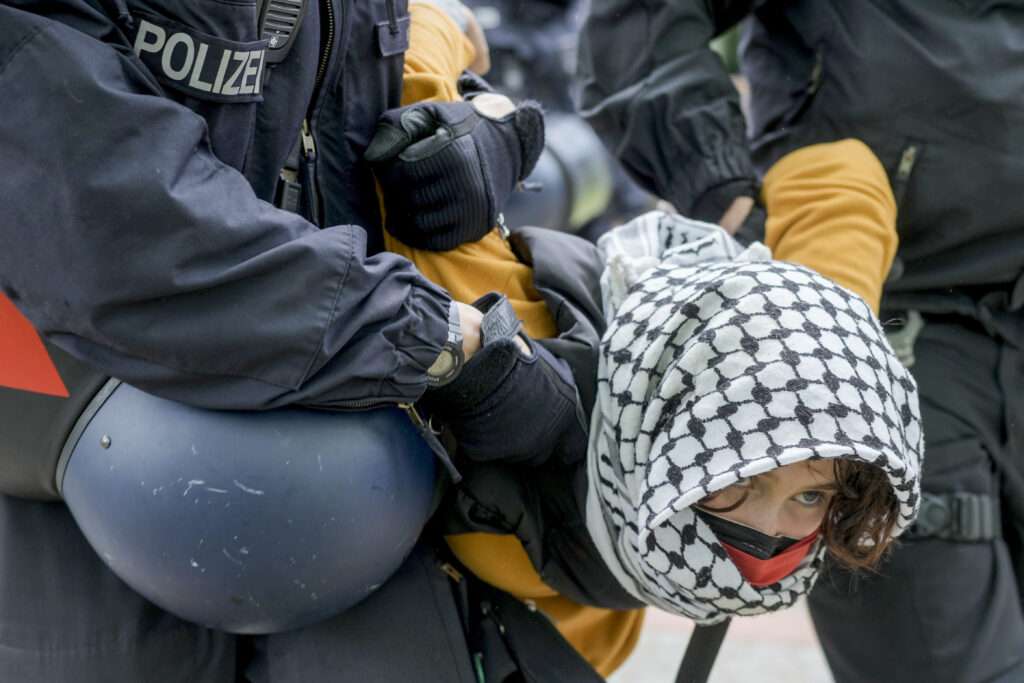 A woman is arrested during a pro-Palestinian demonstration at the Freie Universität Berlin, May 7, 2024. (AP Photo/Markus Schreiber, used pursuant to license from AP Photo)