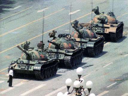 tiananmen square martyr standing in front of a tank