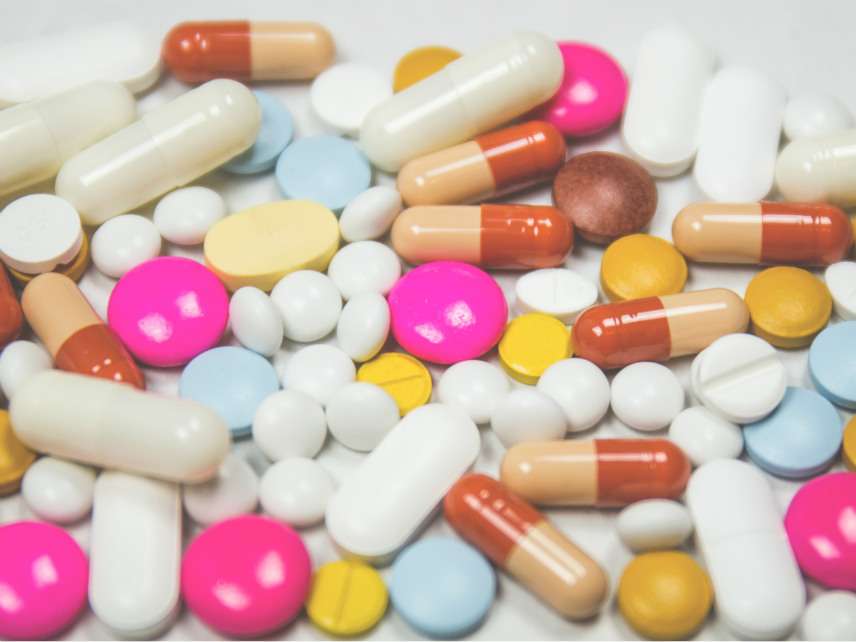 Pile of White Pink and Brown Oblong and Round Medication Tablet