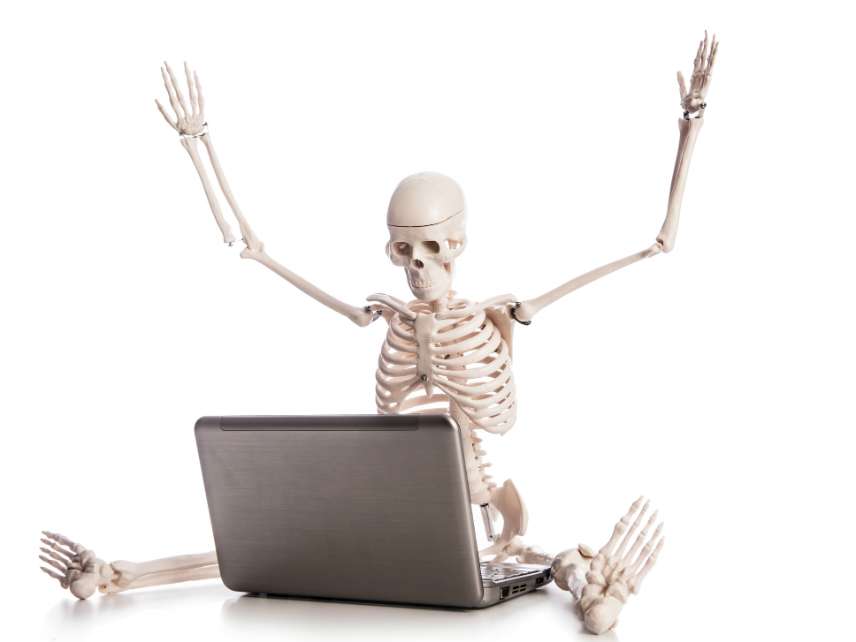 Skeleton working on laptop 