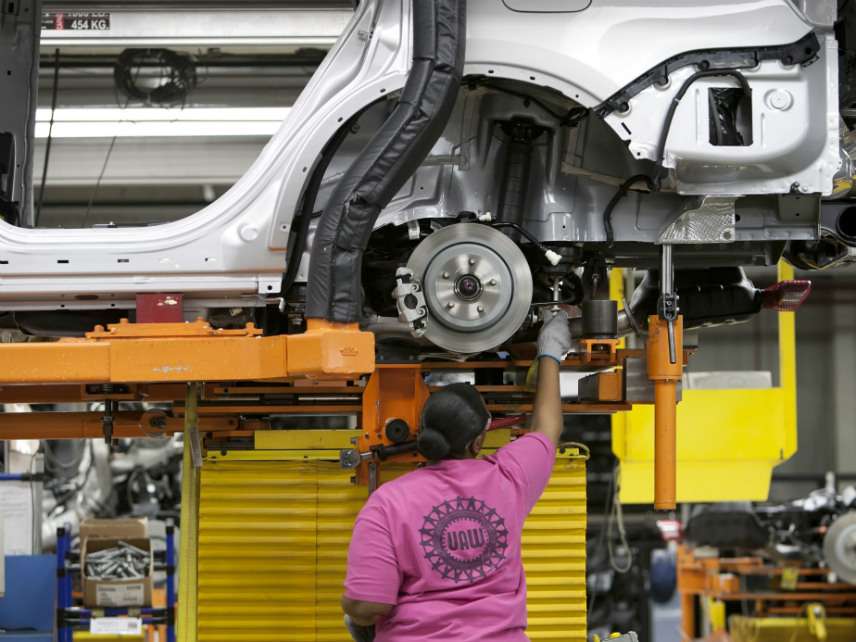 A worker on the assembly line at Chrysler's Jefferson North Assembly Plant, Detroit, Michigan, USA