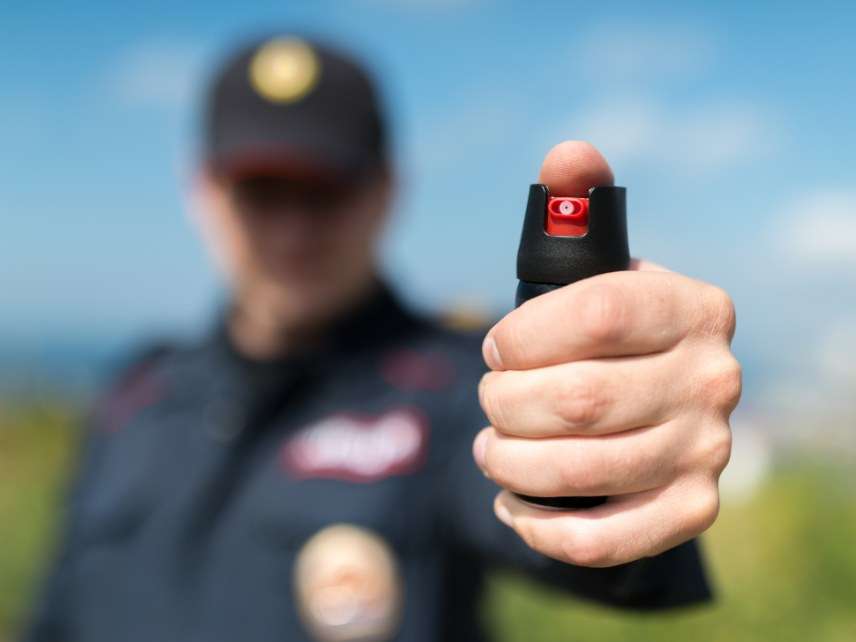 Cop with pepper spray