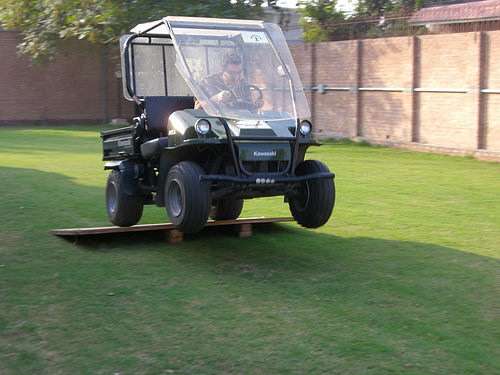 A guy ramping a golf cart