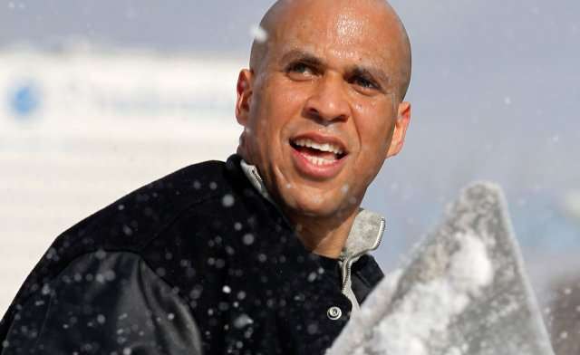 Cory Booker shoveling snow