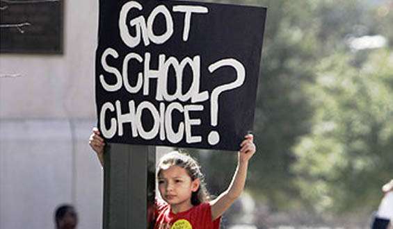 Girl holding a sign for school choice