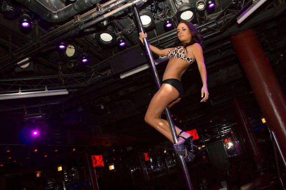 Table dancers perform on a pole in the Table Dance Bar Boobs