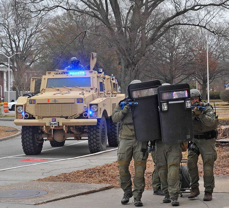 Confronting a terrorist cell? Nope. A home with missing roofing tiles.