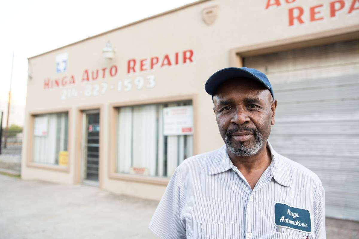 Hinga Mboko in front of his shop