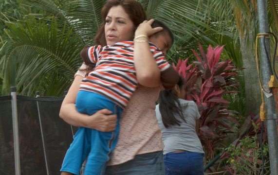 Nora with a child who has been affected by deportation