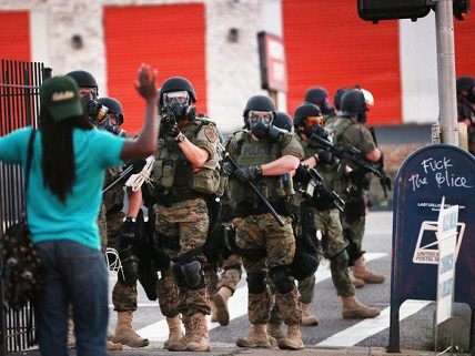 Man holds hands up for SWAT team in Ferguson