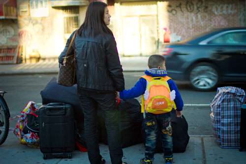 A woman and her son wait for a bus from New York City to Tampa ||| Jim Epstein