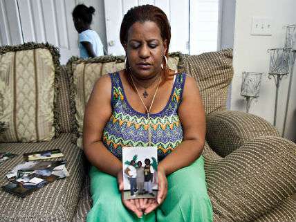Stephanie George's sister, Wendy Evil, with a photo of her sister's children
