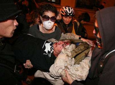 Occupy Oakland protestors carry 24-year-old Scott Olsen, who suffered massive head injuries after allegedly being struck by a tear gas canister fired by police.