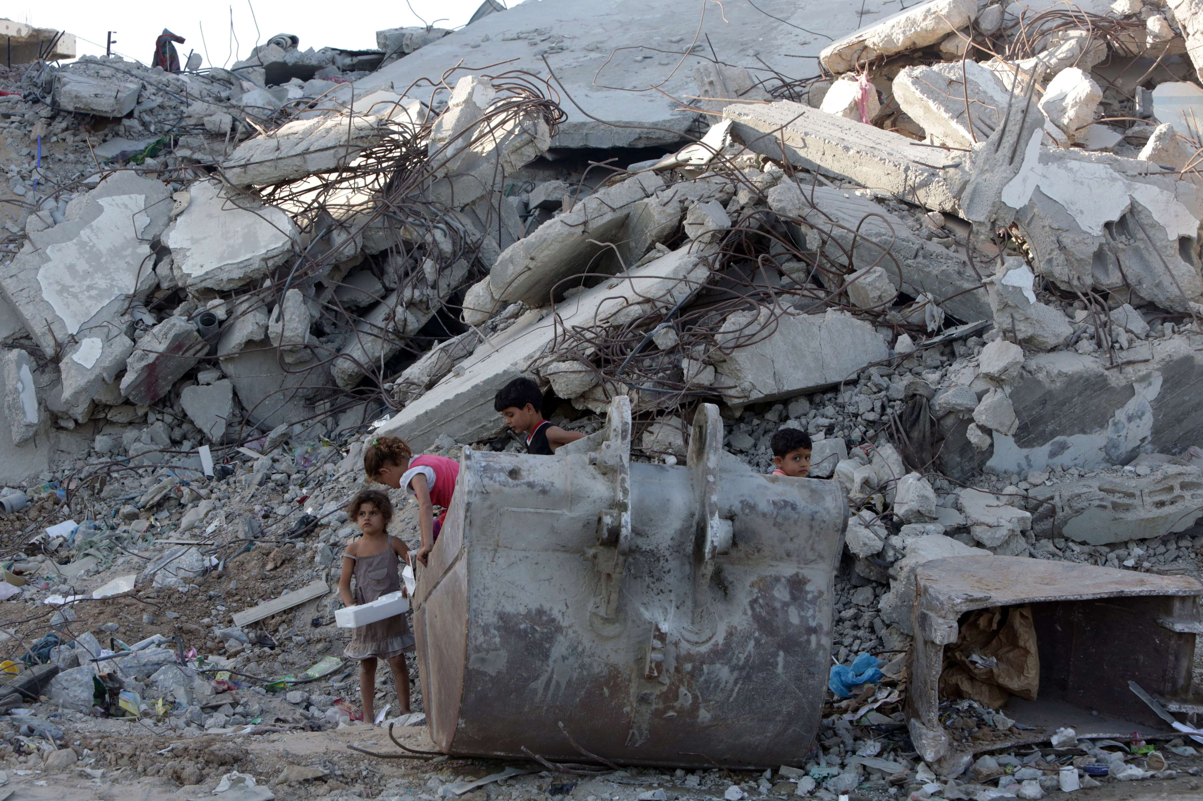 Palestinian children play in the rubble of buildings on June 22, 2015 in Gaza City that were destroyed during 50-day war between Israel and Hamas-militants in the summer of 2014. (Mahmud Hams/AFP/Getty Images)